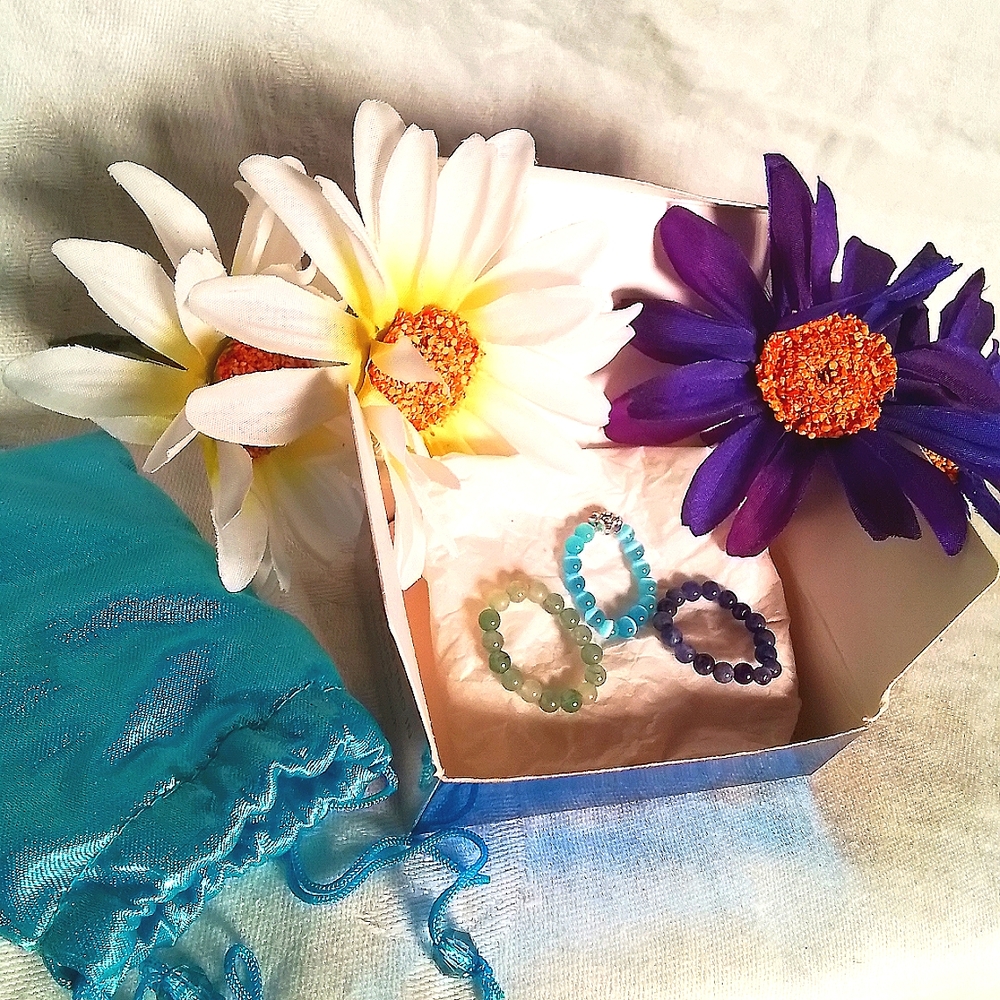 Beaded Ring Trio(1 has a metal w/ stones flower charm) in a Turquoise silk bag